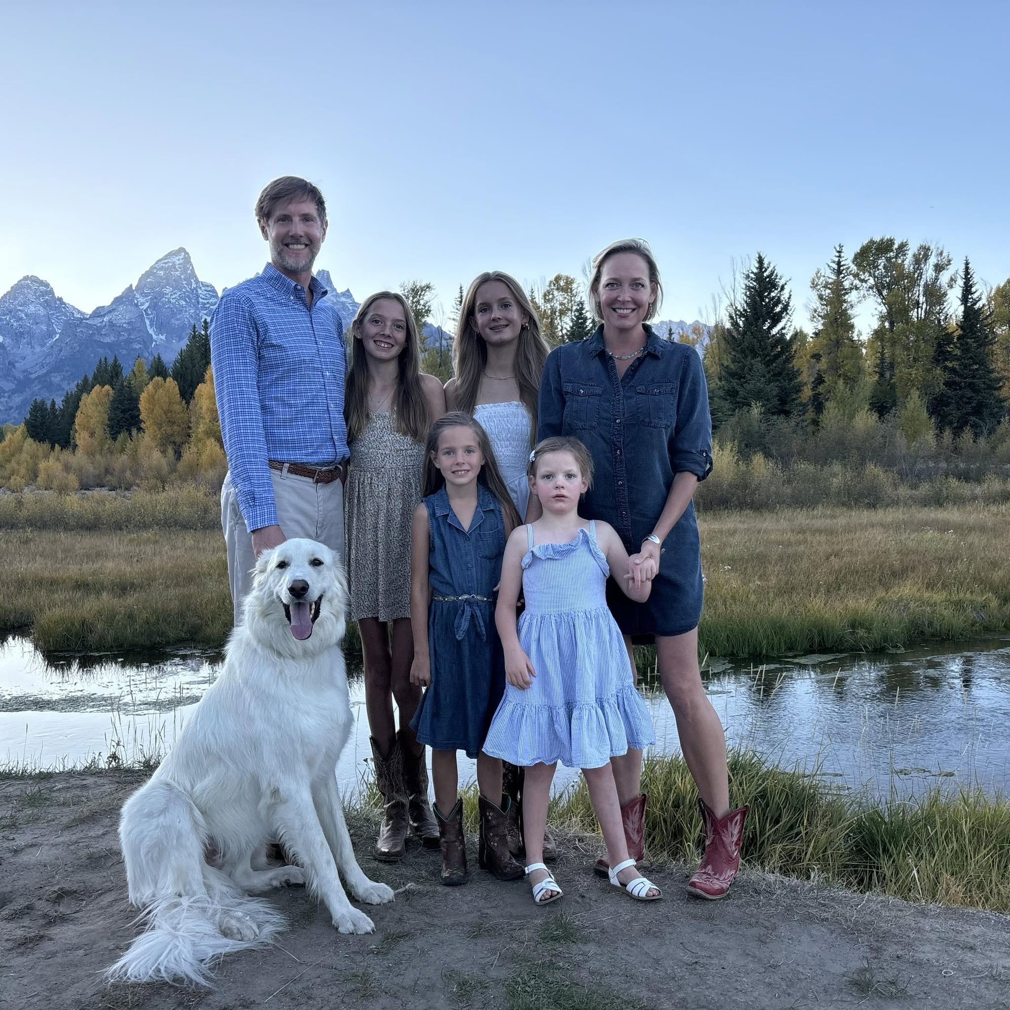 Rebecca Bextel with her husband, Jonathan, their four daughters, and their dog in front of the Grand Tetons